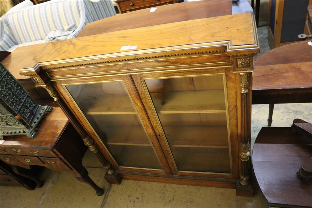 A Victorian parcel gilt walnut inverse breakfront bookcase, width 112cm, depth 27cm, height 118cm